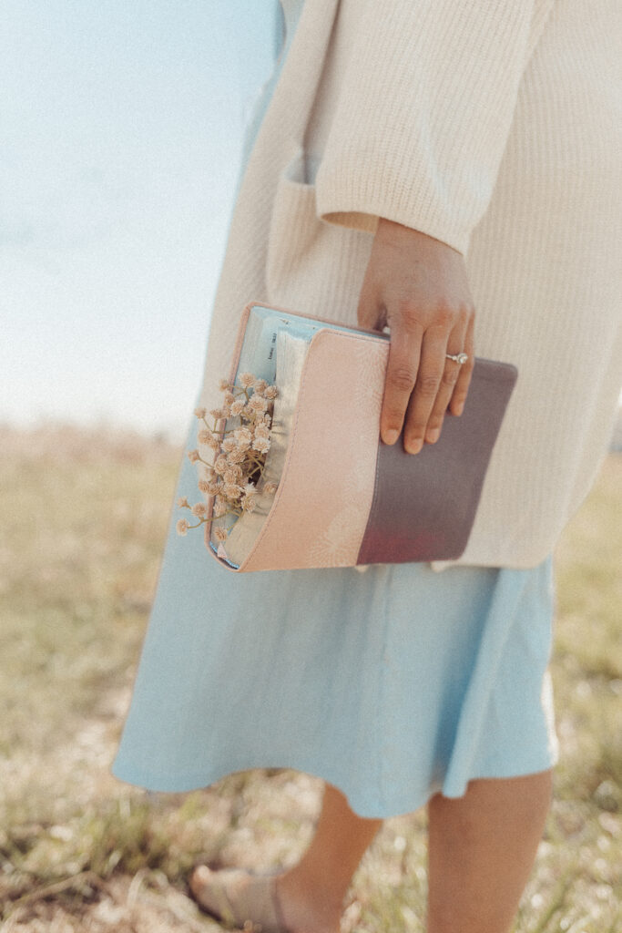 woman holds bible with flowers during mini session in Lawton, OK