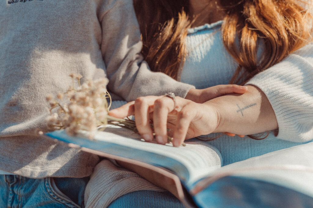 Mother holds flowers and bible during mini session in Lawton, OK