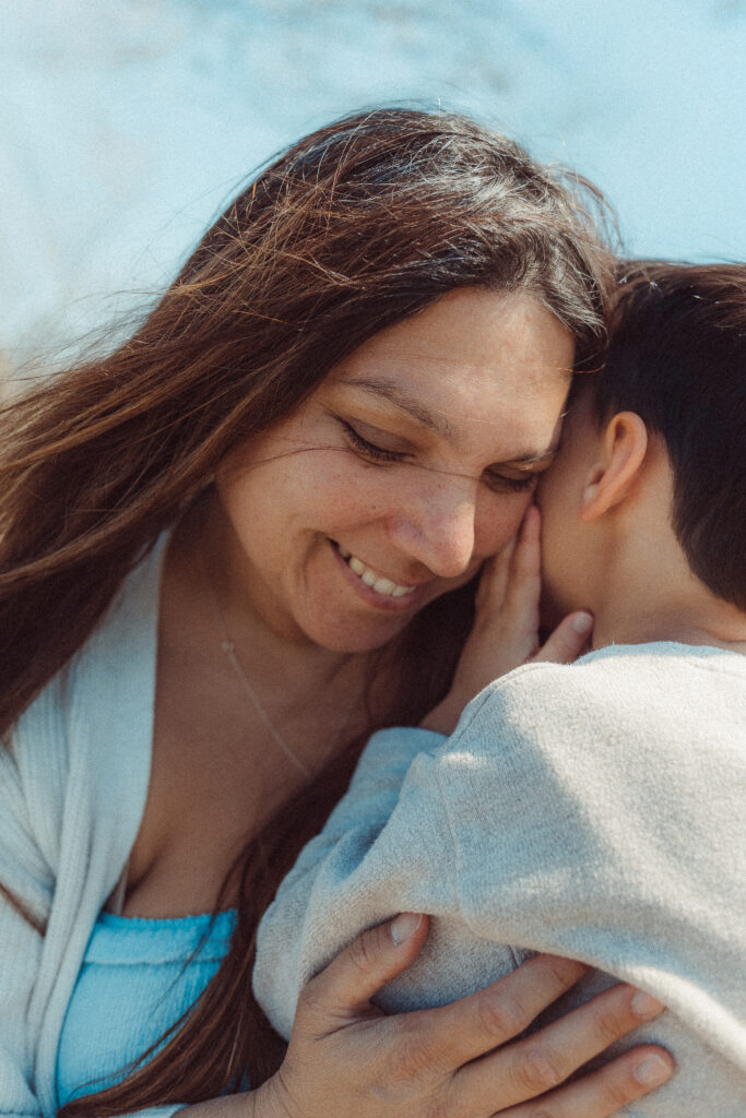 boy whispers to mother during mother's day mini session in Lawton, OK