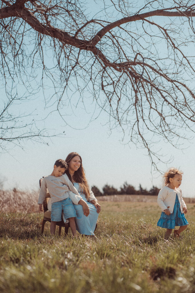mother looks on as child walks away during mother's day mini session in Lawton OK
