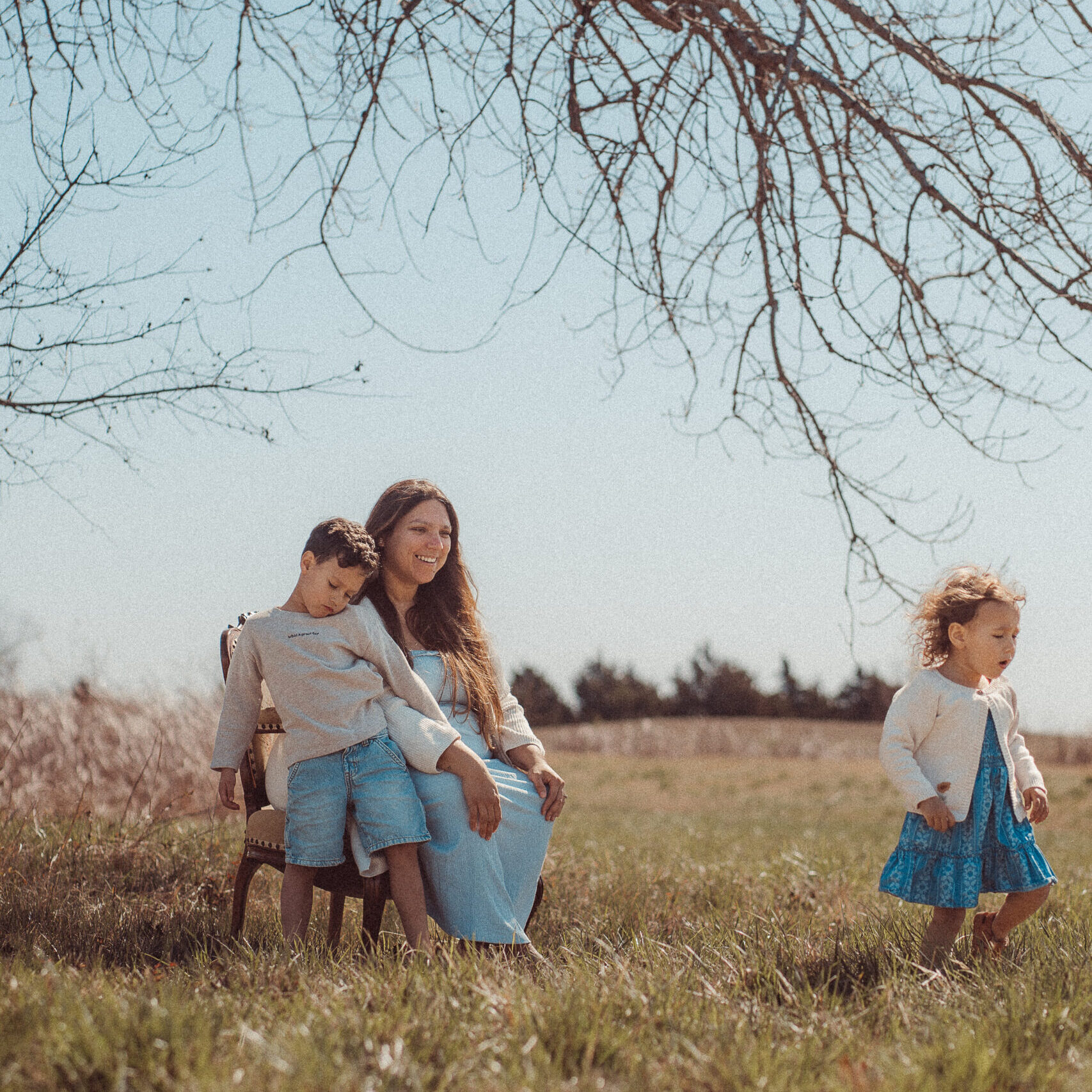 mother looks on as child walks away in mini session in Lawton, OK