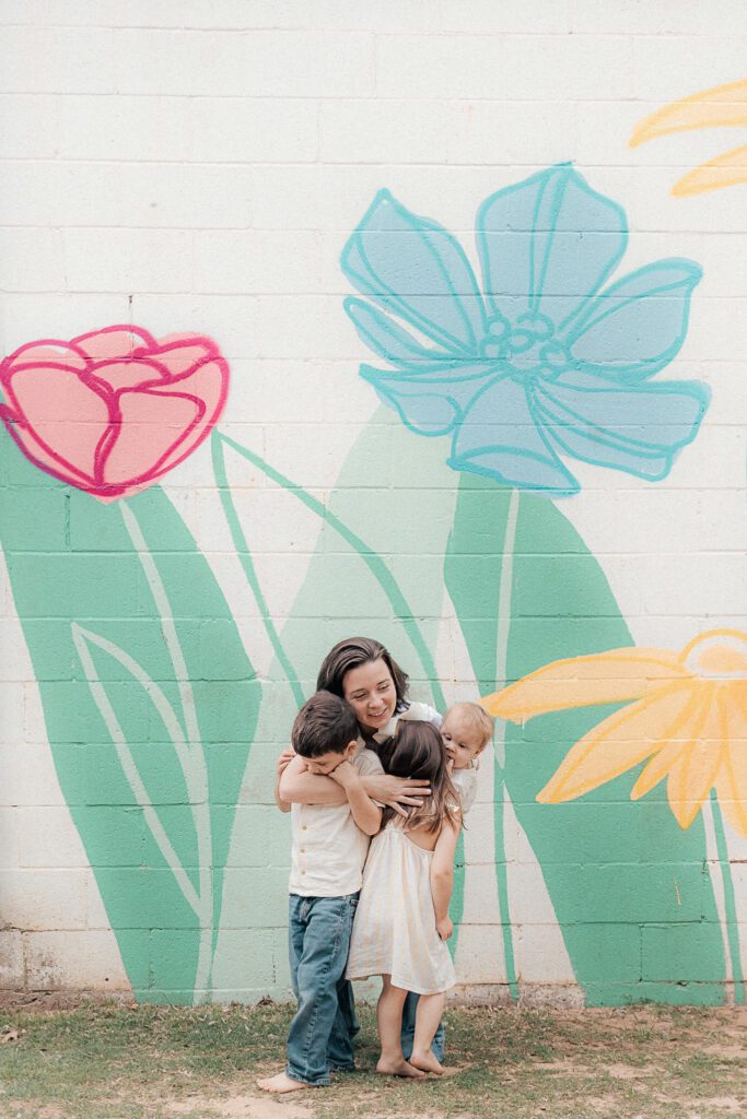 mother hugs her children during a mother's day mini session in lawton, ok