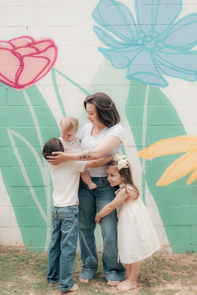 children hug their mother during a mother's day mini session in lawton, ok