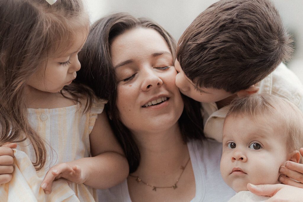 mother embraces her children during a mother's day mini session in Lawton OK