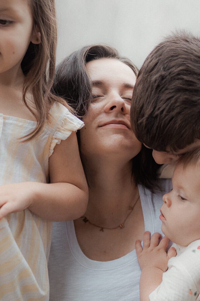 mother soaks in a sweet moment with her children during a mother's day mini session in lawton, OK