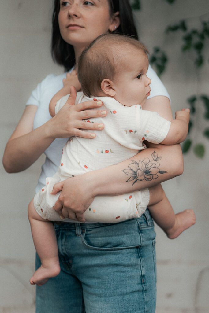 mother holds her baby during a mother's day mini session in lawton, ok