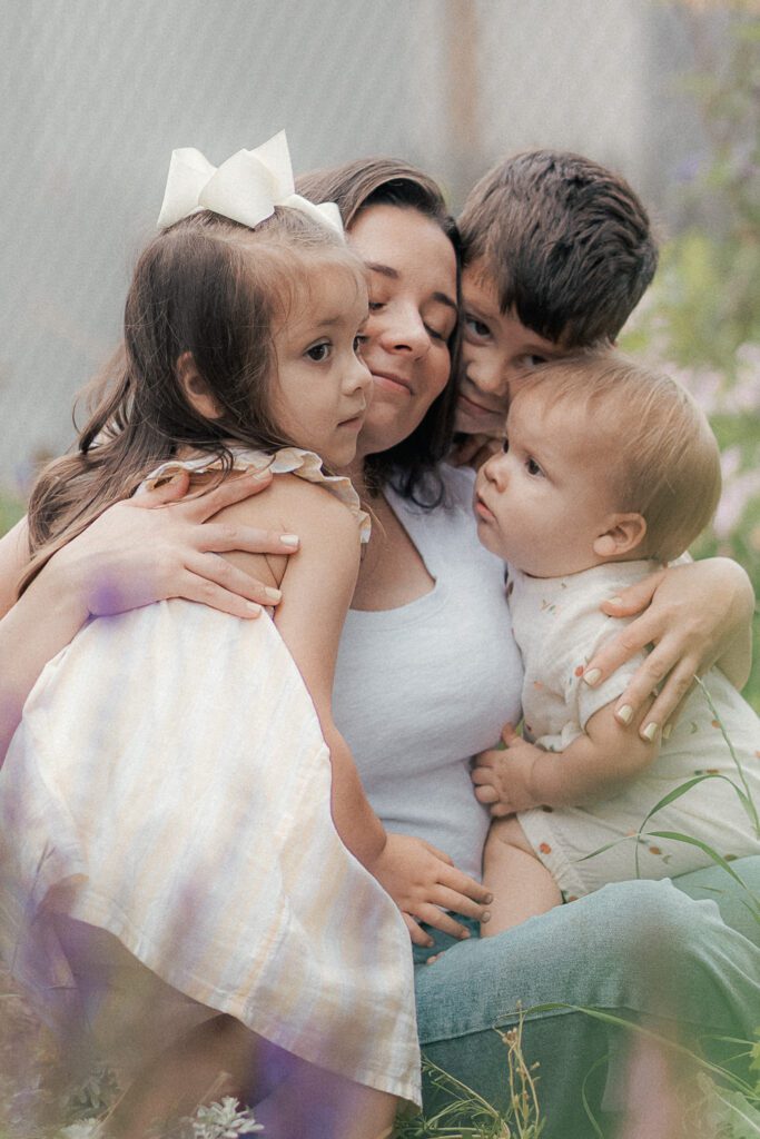 mom embraces her children during mother's day mini session in lawton, ok